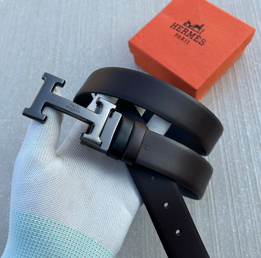 Black reversible leather belt with silver H buckle and textured center strap