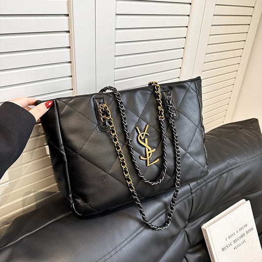 Quilted black tote bag with gold YSL logo and twin chain shoulder straps
