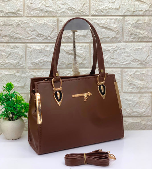 Women’s PU leather tote bag with top handles and sling strap, brown with gold accents.