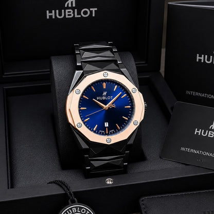 Bold black and rose gold chronograph watch for men with a deep blue dial, date display, and stainless steel bracelet.