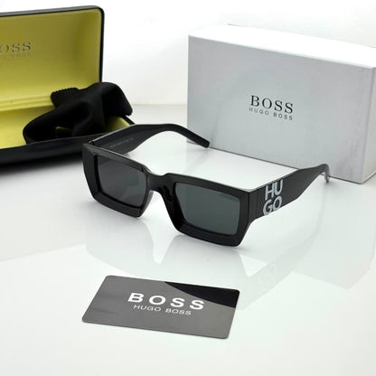 Bold rectangular black sunglasses with dark UV-protective lenses, stylish oversized unisex frame, displayed with premium storage box and accessories.