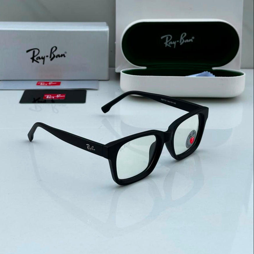 Premium matte black square blue light blocking eyeglasses with clear lenses displayed alongside protective case and accessories on a white surface.