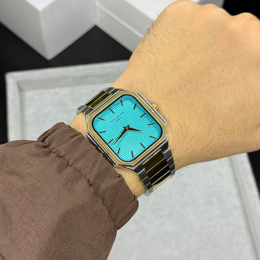 Premium rectangular ocean blue dial quartz watch for men with stainless steel bracelet and luxury finish displayed in hand.