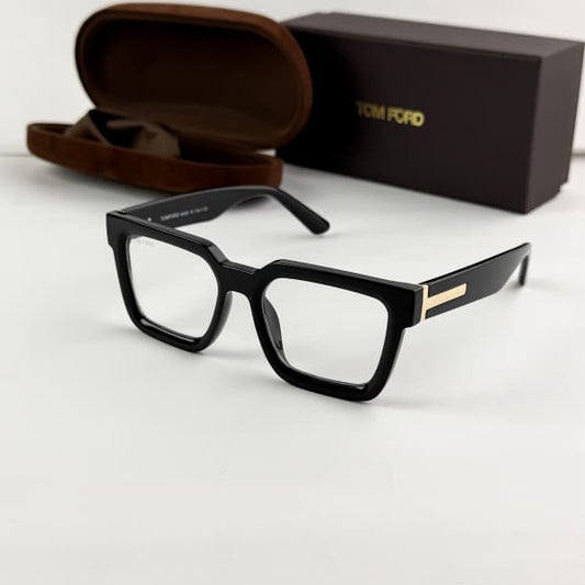 Tom Ford black square eyeglasses frame with clear lenses, glossy finish and signature gold-tone T detail on the temples