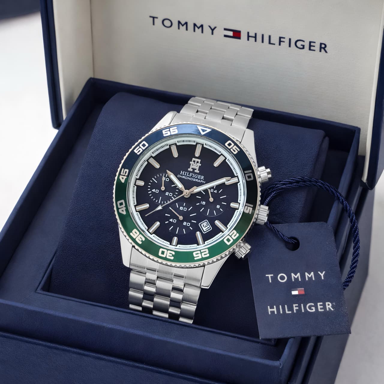 Tommy Hilfiger watch with silver and green accents in a branded box
