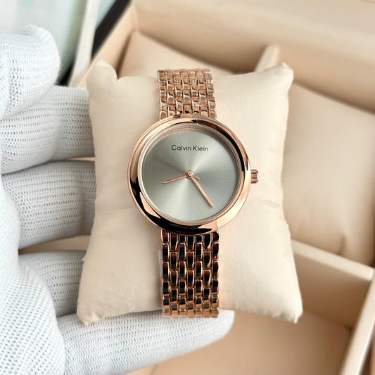 Women’s analog watch with light green dial, rose-gold case, and rose-gold metal bracelet