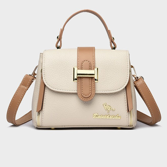 Cream leather-look sling bag with front flap, tan buckle, and adjustable shoulder strap