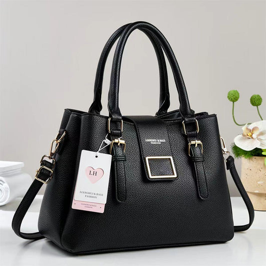 Black PU leather handbag with top handles, front square buckle, and shoulder strap.