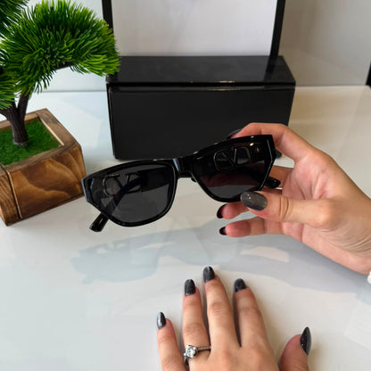 Women's black cat eye sunglasses with UV-protective dark lenses, glossy lightweight frame, stylish fashion eyewear for everyday wear, travel, shopping, and outdoor occasions.